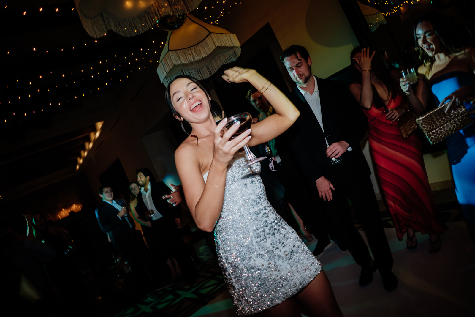 Bride celebrating and dancing during a destination wedding reception in Tulum Mexico