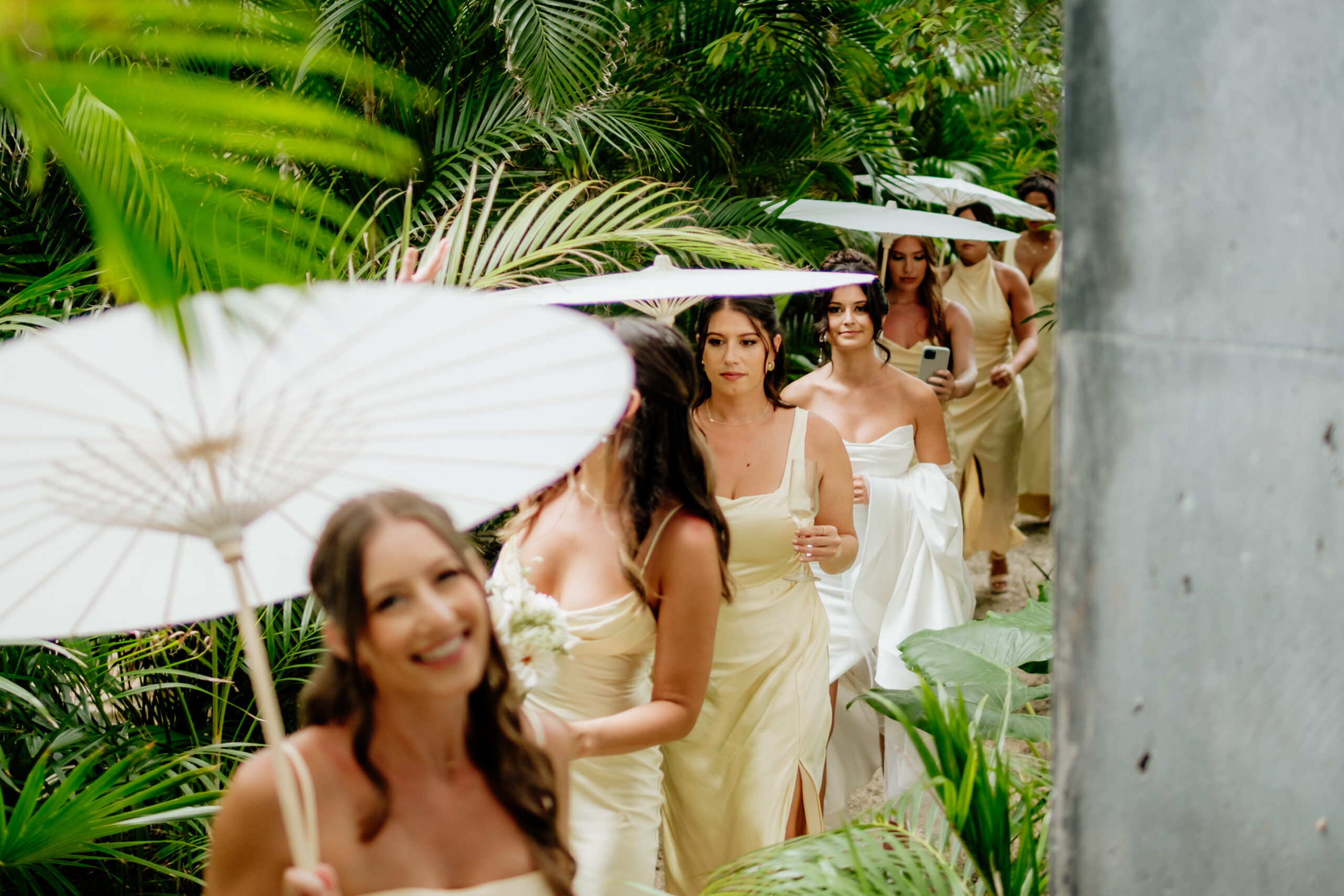 Bridesmaids walking together during a destination wedding ceremony in Tulum Mexico