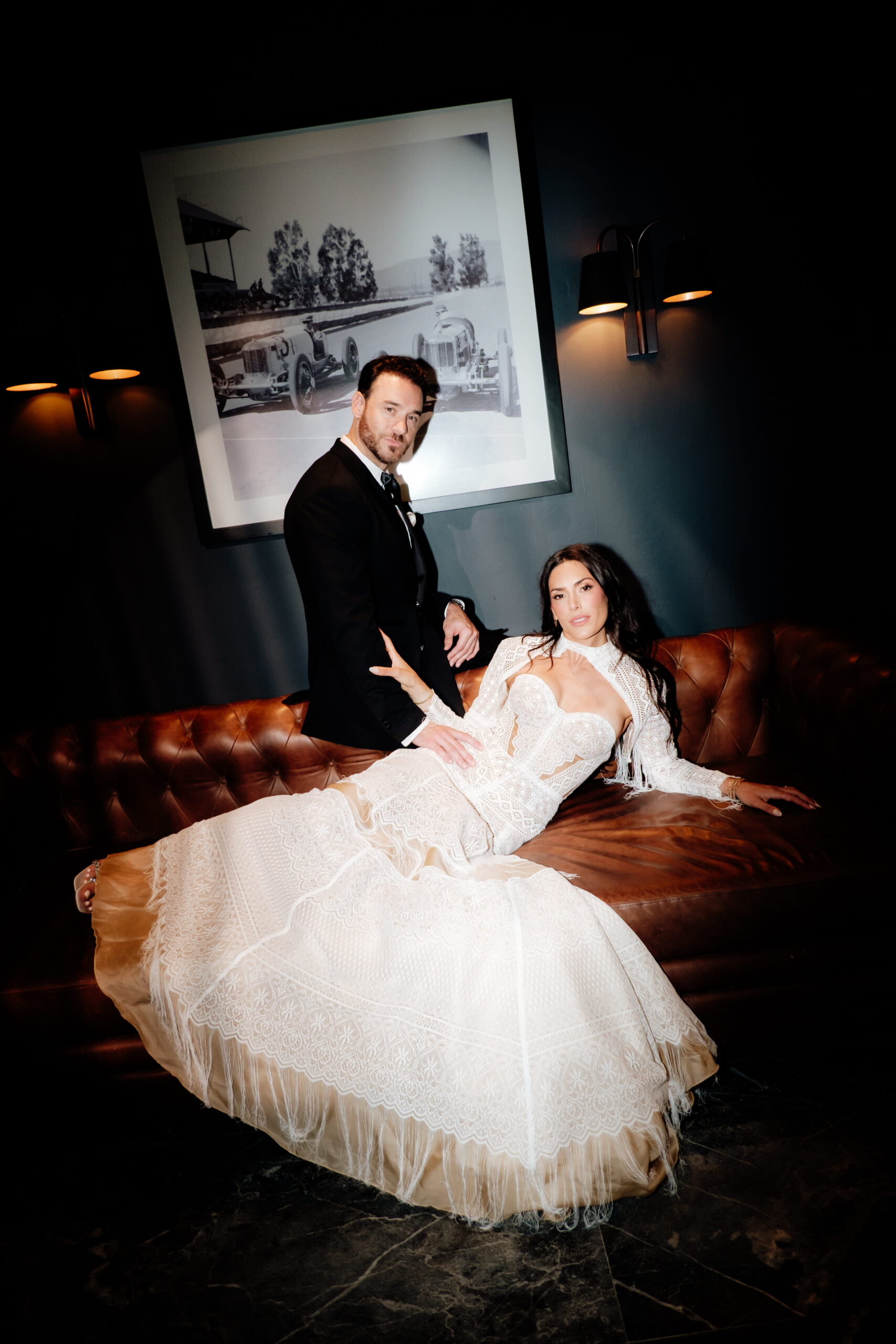 Bride posing on a bar counter during an evening wedding reception in Tulum Mexico