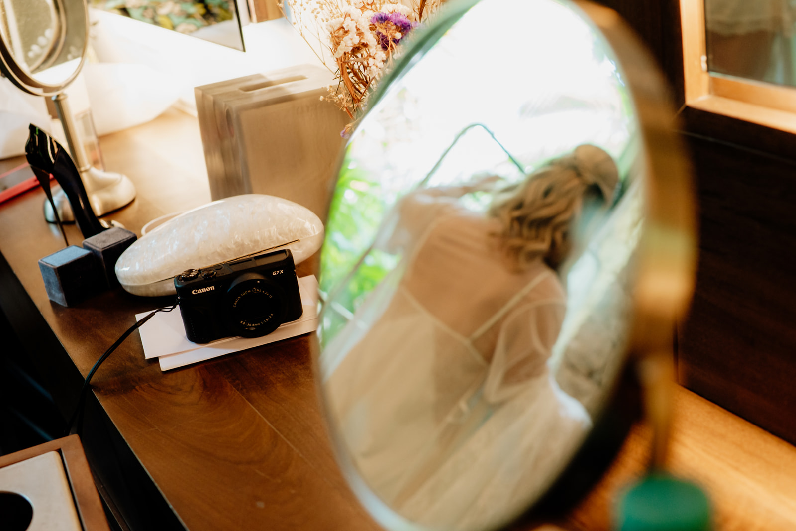 Bride seen in a mirror during bridal preparations before a destination wedding in Tulum