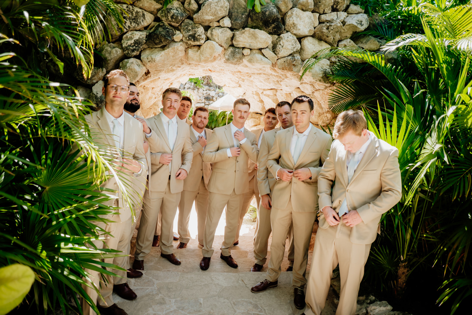 Groom and groomsmen standing together before a destination wedding ceremony in Tulum Mexico