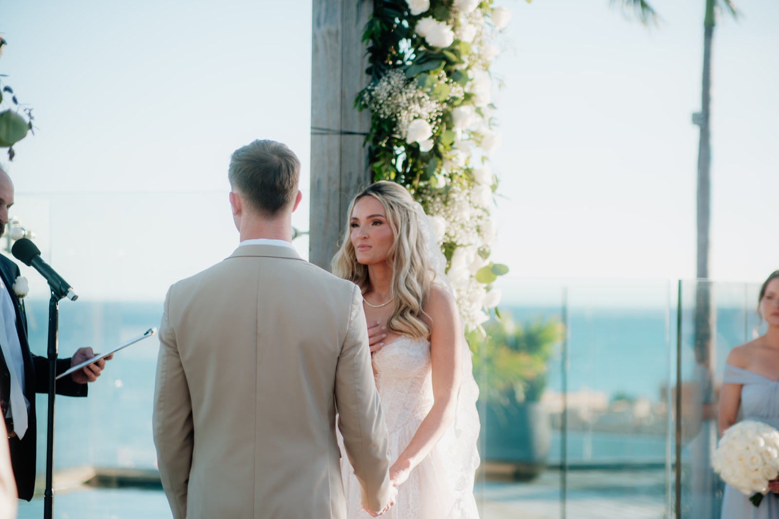 Bride and groom standing together during a beach wedding ceremony in Tulum Mexico