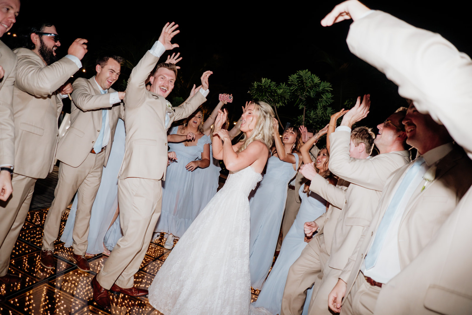 Bride dancing with friends and wedding guests during a destination wedding reception in Tulum Mexico